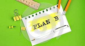 Text PLAN B sign showing on green background with office tools