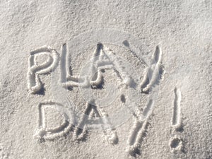 Text `Play Day !` written in freshly fallen snow concept.