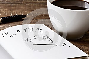 Text poetry day in a notebook and a cup of coffee