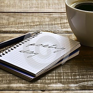 Text poetry day in a notebook and a cup of coffee