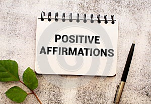 The text POSITIVE AFFIRMATIONS appearing behind torn paper.