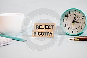 Text Prevent Bigotry written in blue under a wire mesh