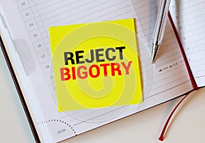 Text Prevent Bigotry written in blue under a wire mesh