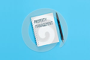 The text Property management is written on a notebook page