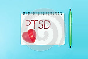 Text PTSD of Posttraumatic stress disorder on paper with rubber