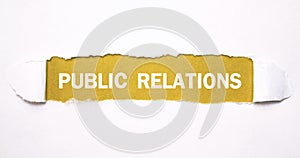 Text Public Relations on torn paper photo