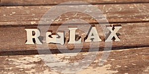 text RELAX from wooden letter alphabet in the sun on a sunny day