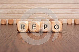 the text REPO is written on wooden cubes on a brown background
