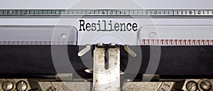 Text `resilience` typed on retro typewriter. Business concept