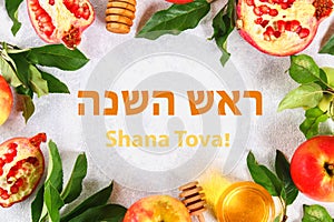 Text Rosh Hashanah on Hebrew. jewish New Year holiday concept. Traditional symbol. Apples, honey, pomegranate. Shana tova. Top vie