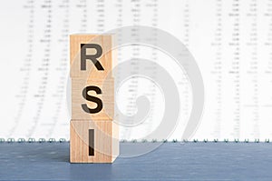 Text rsi on vertical row of wooden blocks on the background of columns of numbers