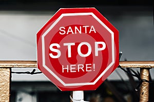 Text santa stop here in a signboard