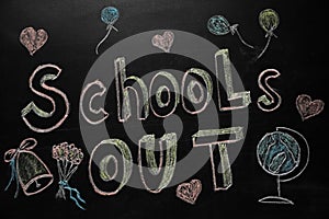 Text SCHOOL`S OUT and different drawings on blackboard. Summer holidays