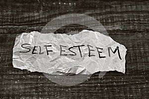 Text self esteem written in a piece of paper