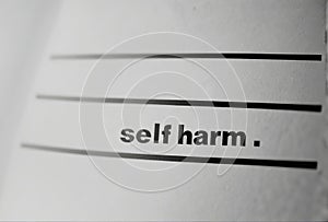Text Self harm on white paper