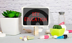 text SEX EDUCATION in the middle on a wooden table.