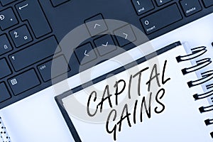 Text showing inspiration Capital Gains. Concept meaning Bonds Shares Stocks Profit Income Tax Investment Funds Computer