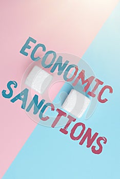 Text showing inspiration Economic Sanctions. Conceptual photo Penalty Punishment levied on another country Trade war Two
