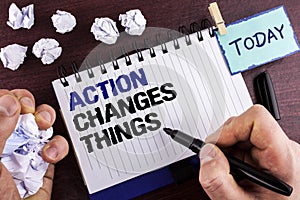 Text sign showing Action Changes Things. Conceptual photo doing something is like chain Improve Reflects written by Man on Notepad