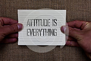 Text sign showing Attitude Is Everything. Conceptual photo Positive Outlook is the Guide to a Good Life Man holding piece notebook