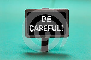 Text sign showing Be Careful. Conceptual photo making sure of avoiding potential danger mishap or harm Blackboard green background