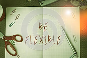 Text sign showing Be Flexible. Conceptual photo able to be easily modified to respond to altered circumstances Scissors