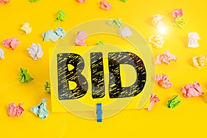 Text sign showing Bid. Conceptual photo to offer a particular amount of money for something that is for sale Colored crumpled