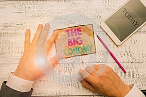 Text sign showing The Big Economy. Conceptual photo Global finances Worldwide Market Trade Money exchange Hand hold note