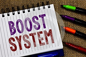 Text sign showing Boost System. Conceptual photo Rejuvenate Upgrade Strengthen Be Healthier Holistic approach Open spiral notebook
