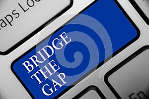 Text sign showing Bridge The Gap. Conceptual photo Overcome the obstacles Challenge Courage Empowerment Keyboard blue key Intentio