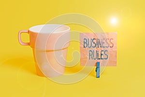 Text sign showing Business Rules. Conceptual photo a specific directive that constrains or defines a business Cup empty paper blue