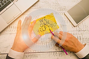 Text sign showing We Can Help You. Conceptual photo offering good assistance to customers or friends Hand hold note