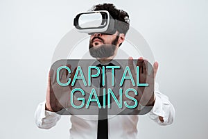 Text sign showing Capital Gains. Business concept Bonds Shares Stocks Profit Income Tax Investment Funds Man Wearing Vr