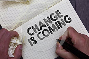 Text sign showing Change Is Coming. Conceptual photo telling someone that future going to be different Man holding marker notebook