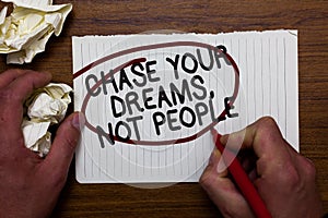 Text sign showing Chase Your Dreams, Not People. Conceptual photo Do not follow others chasing goals objectives Hand hold paper lo