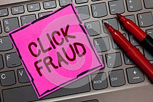 Text sign showing Click Fraud. Conceptual photo practice of repeatedly clicking on advertisement hosted website Pink paper keyboar