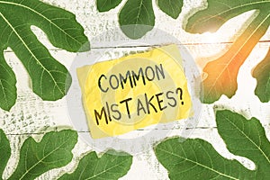 Text sign showing Common Mistakes Question. Conceptual photo repeat act or judgement misguided making something wrong Leaves