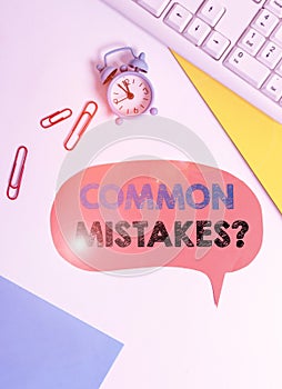Text sign showing Common Mistakes question. Conceptual photo repeat act or judgement misguided or wrong Flat lay above table with