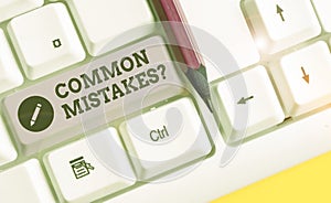 Text sign showing Common Mistakes question. Conceptual photo repeat act or judgement misguided or wrong White pc keyboard with