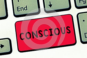 Text sign showing Conscious. Conceptual photo aware of and responding to ones surroundings using his senses Keyboard key