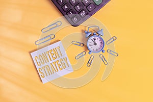 Text sign showing Content Strategy. Conceptual photo create marketing plan using good photos and words Metal retro alarm clock