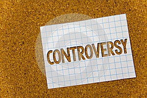 Text sign showing Controversy. Conceptual photo Disagreement or Argument about something important to people Cork background noteb