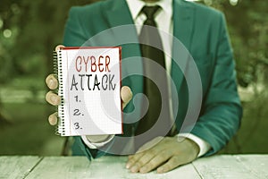 Text sign showing Cyber Attack. Conceptual photo An attempt by hackers to Damage Destroy a Computer System Man holds