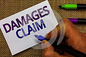 Text sign showing Damages Claim. Conceptual photo Demand Compensation Litigate Insurance File Suit Man hand holding marker white p