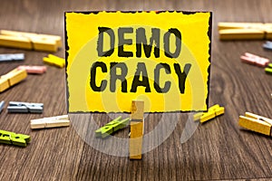 Text sign showing Demo Cracy. Conceptual photo freedom of the people to express their feelings and beliefs Clothespin holding yell