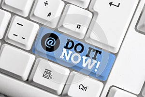 Text sign showing Do It Now. Conceptual photo not hesitate and start working or doing stuff right away White pc keyboard with