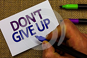 Text sign showing Don t not Give Up. Conceptual photo Determined Persevering Continue to Believe in Yourself Man hand holding mark