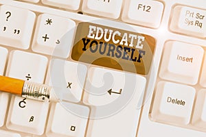 Text sign showing Educate Yourself. Conceptual photo prepare oneself or someone in a particular area or subject White pc keyboard