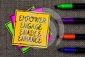 Text sign showing Empower Engage Enable Enhance. Conceptual photo Empowerment Leadership Motivation Engagement Written on some col photo