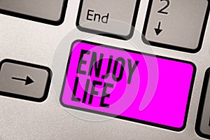 Text sign showing Enjoy Life. Conceptual photo Any thing, place,food or person, that makes you relax and happy Keyboard purple key